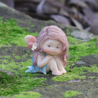 Cute Fairy Sitting with Hands on Her Knees