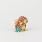 Cute Fairy Sitting with Hands on Her Knees