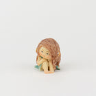 Cute Fairy Sitting with Hands on Her Knees