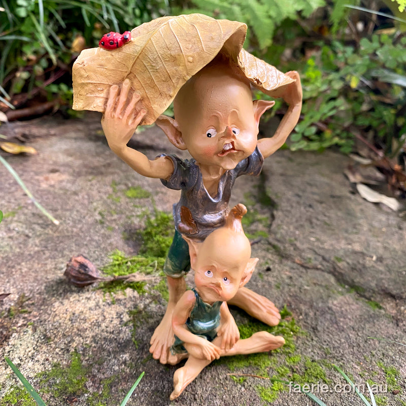 Pixie Brothers trying to Shelter from the Rain Under a Leaf