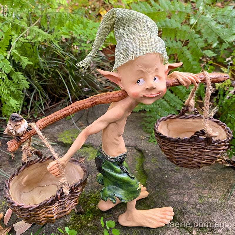 Larger Pixie Carrying Two Baskets on a Tree Branch