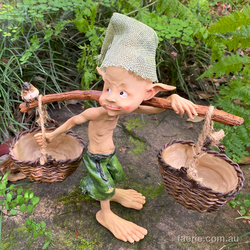 Larger Pixie Carrying Two Baskets on a Tree Branch