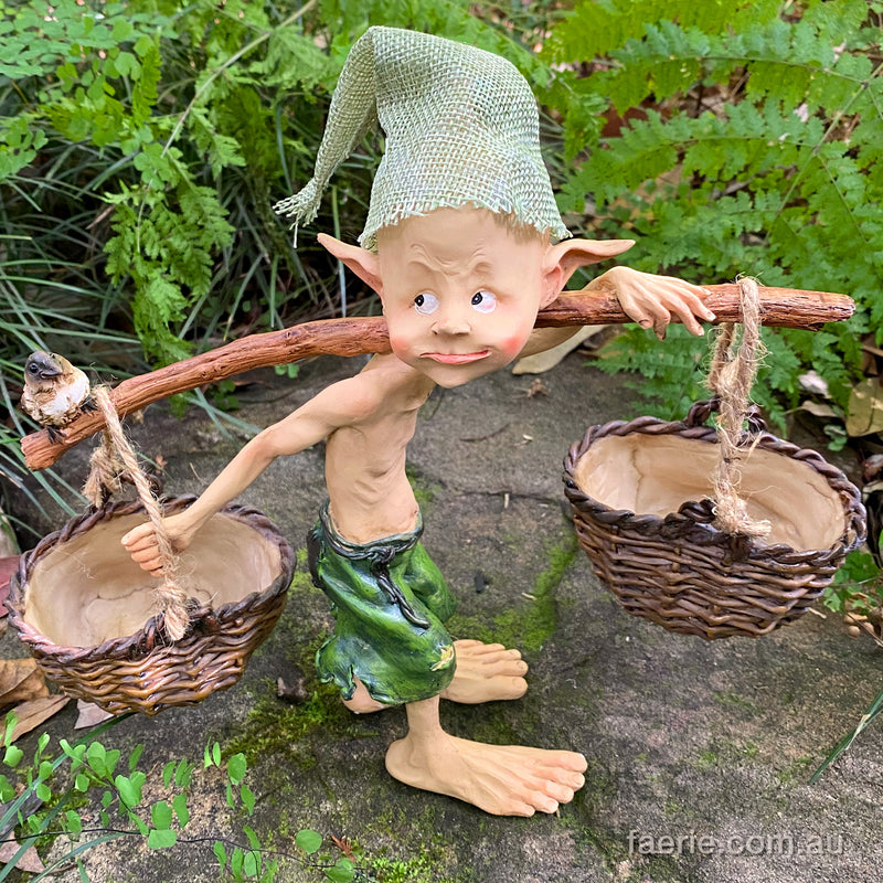 Larger Pixie Carrying Two Baskets on a Tree Branch