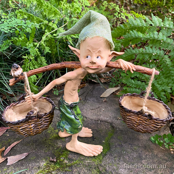 Larger Pixie Carrying Two Baskets on a Tree Branch