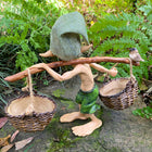 Larger Pixie Carrying Two Baskets on a Tree Branch