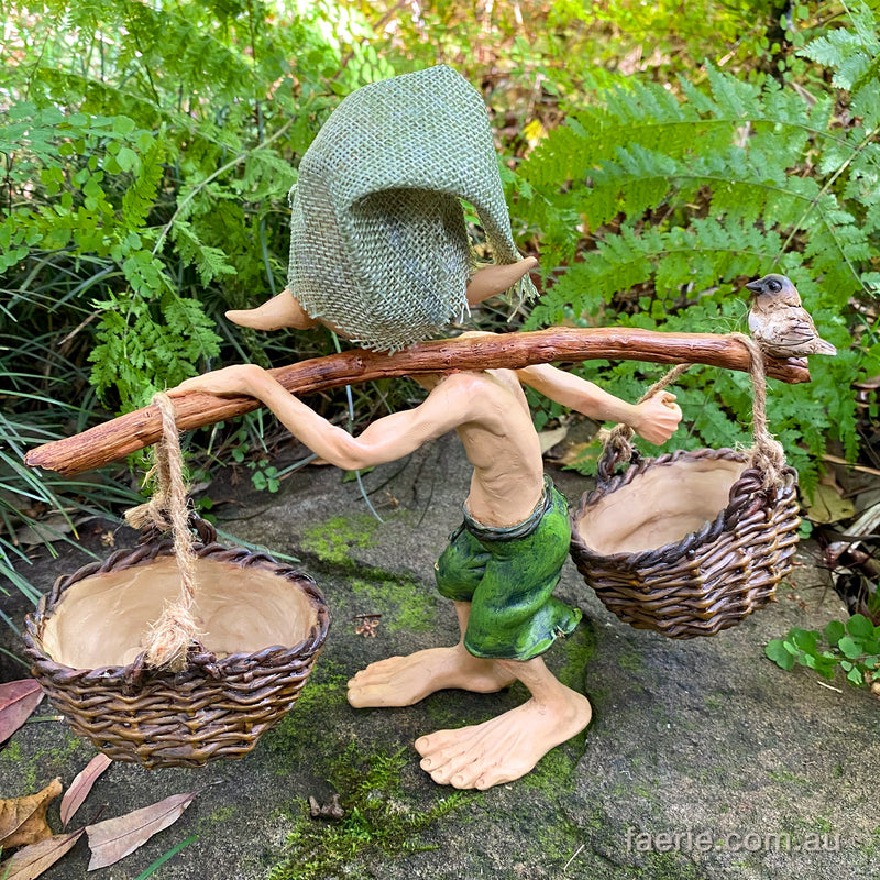 Larger Pixie Carrying Two Baskets on a Tree Branch