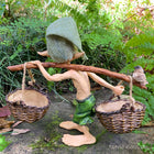 Larger Pixie Carrying Two Baskets on a Tree Branch