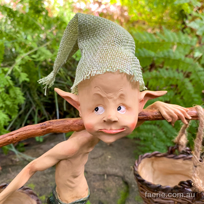 Larger Pixie Carrying Two Baskets on a Tree Branch