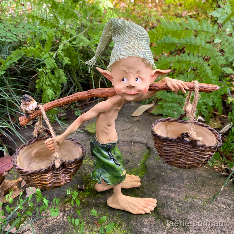 Larger Pixie Carrying Two Baskets on a Tree Branch