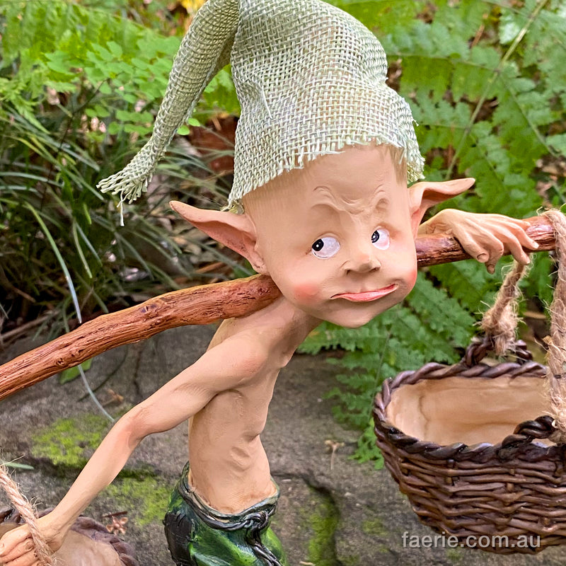 Larger Pixie Carrying Two Baskets on a Tree Branch