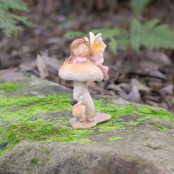 Cute little Fairy Child Asleep on a Mushroom with a little Snail Friend