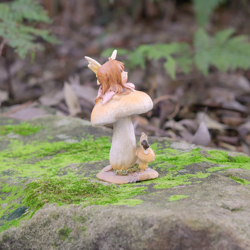 Cute little Fairy Child Asleep on a Mushroom with a little Snail Friend