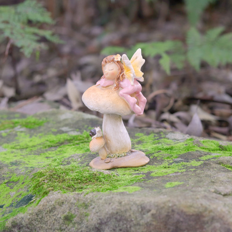 Cute little Fairy Child Asleep on a Mushroom with a little Snail Friend