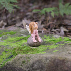 Cute little Fairy Child Sitting on a Rock with her little Frog Friend