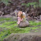 Cute little Fairy Child Sitting on a Rock with her little Frog Friend