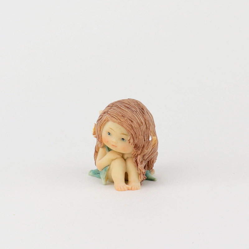 Cute Fairy Sitting with Hands on Her Knees
